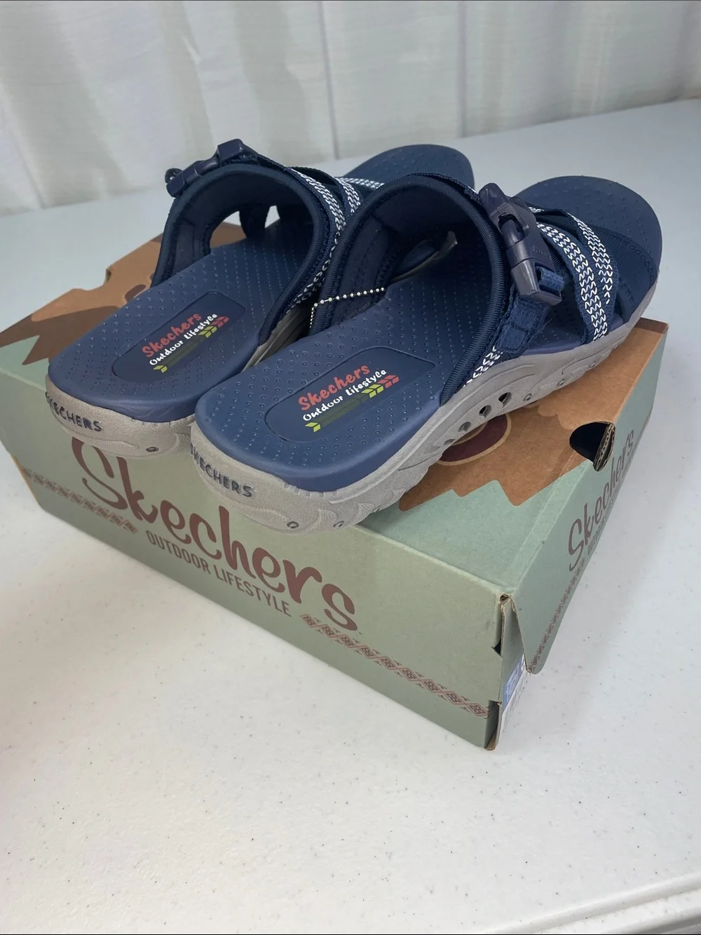 Skechers women’s Navy and White Slip-On Sport Sandals
